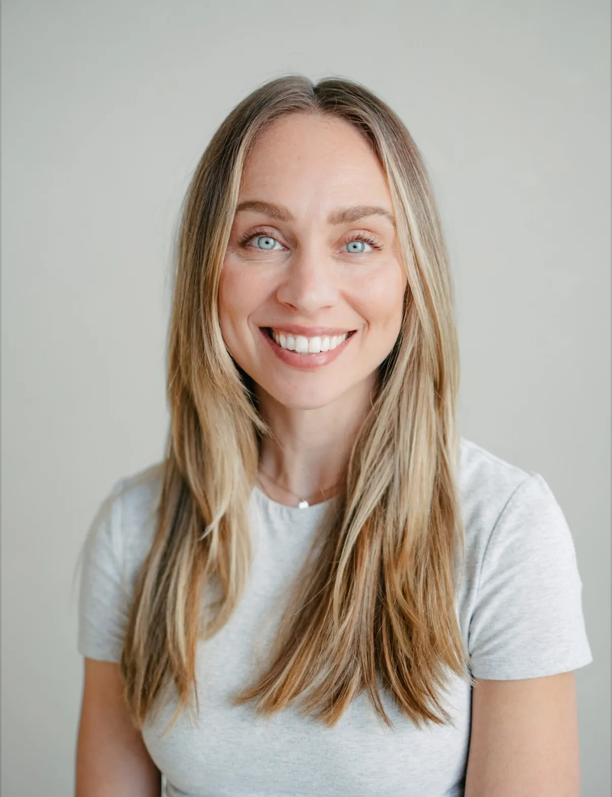Julie Stevenson, Licensed Marriage and Family Therapist, smiling against a pale grey backdrop